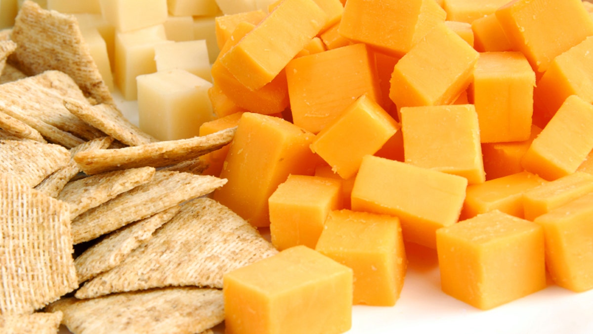 A party tray with swiss and cheddar cheese and crackers