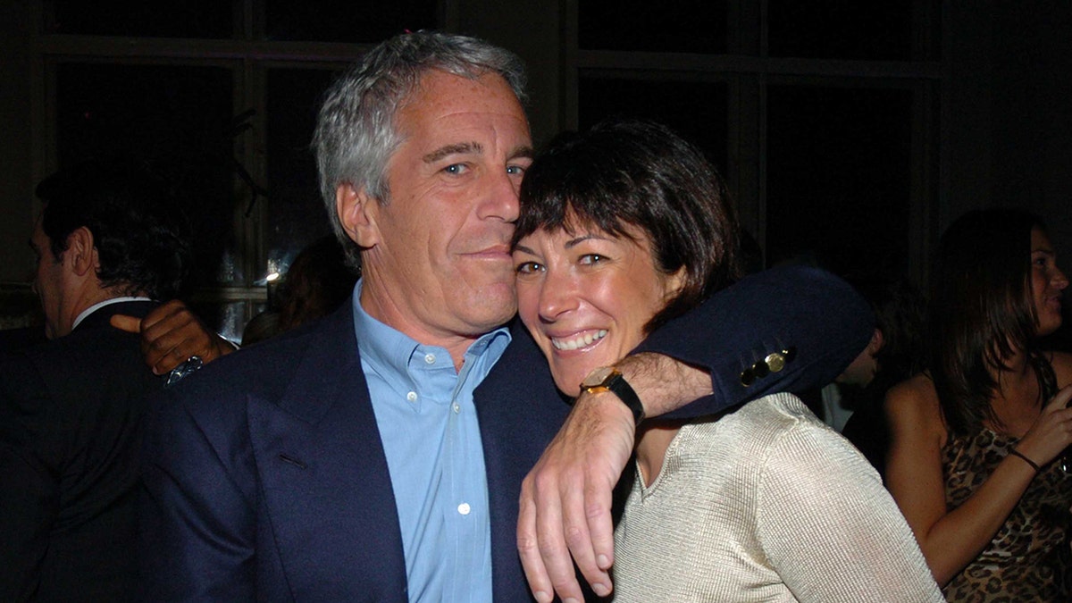 Jeffrey Epstein a black blazer and blue shirt embracing Ghislaine Maxwell in an ivory sweater