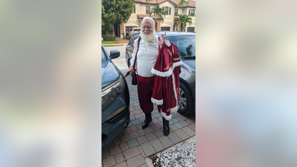 Steve Lantz holding Santa costume